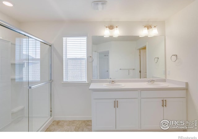 bathroom featuring an enclosed shower and vanity