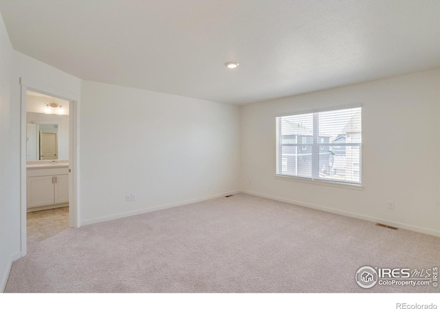 empty room featuring light colored carpet