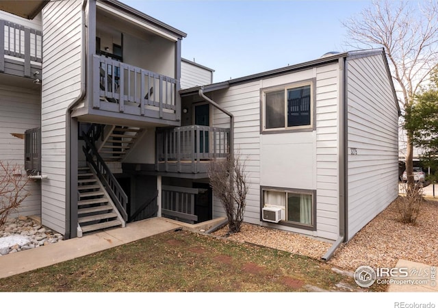 back of house featuring a balcony