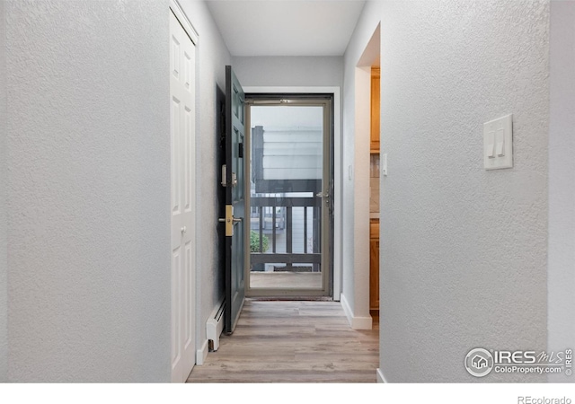 hall with light hardwood / wood-style floors