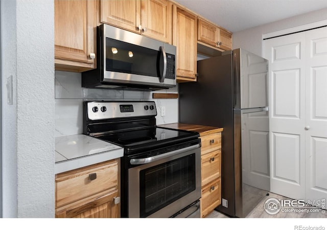 kitchen with stainless steel appliances and light brown cabinetry