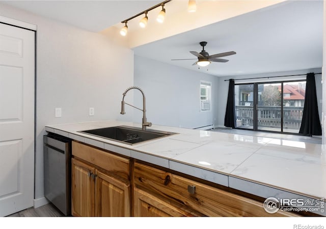 kitchen with dishwasher, sink, tile counters, ceiling fan, and baseboard heating