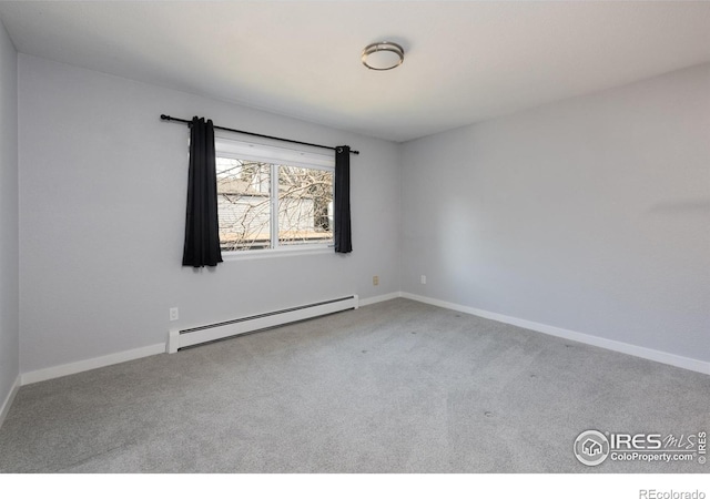 unfurnished room with baseboard heating and carpet floors