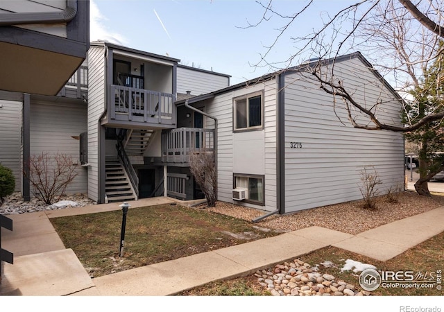 view of side of property with a balcony