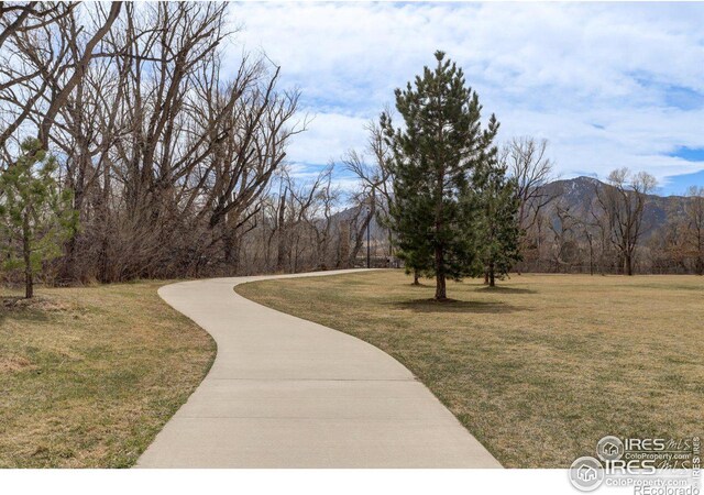 view of home's community featuring a mountain view and a yard