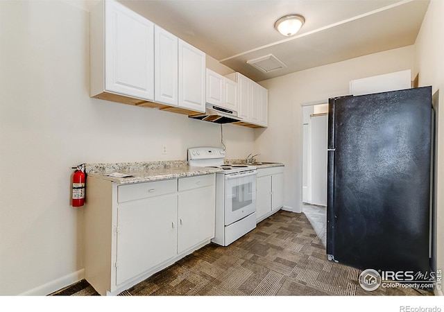 kitchen with sink, black fridge, white cabinetry, electric stove, and light stone countertops