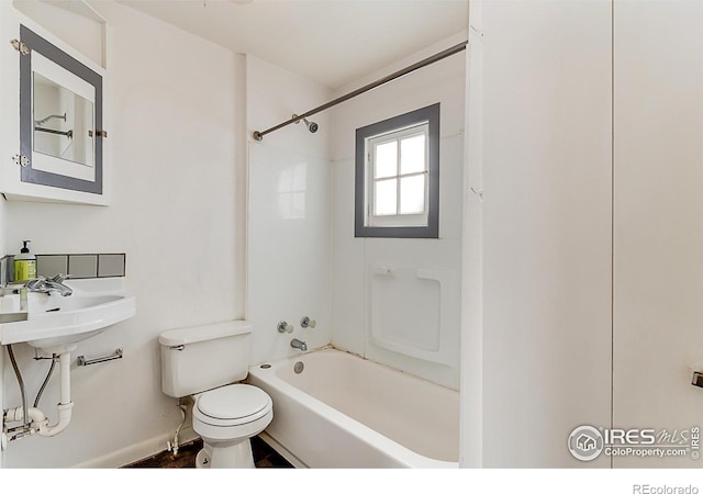 full bathroom featuring toilet, bathing tub / shower combination, and sink