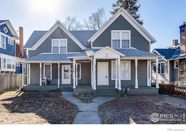1218 8th St, Greeley, CO 80631 - view of front of home featuring fence, a porch, and a shingled roof