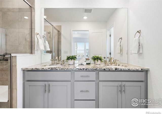 bathroom featuring vanity and an enclosed shower