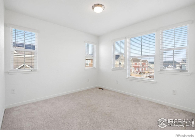 empty room featuring light colored carpet