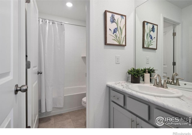 full bathroom featuring tile patterned floors, vanity, toilet, and shower / bath combo