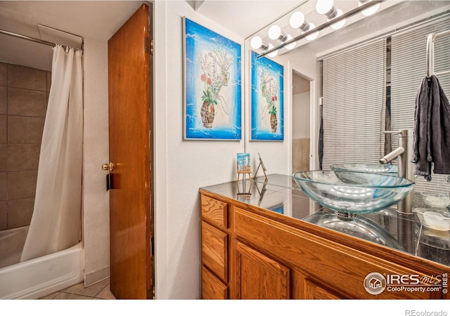 bathroom featuring sink, tile patterned floors, and shower / bath combo with shower curtain