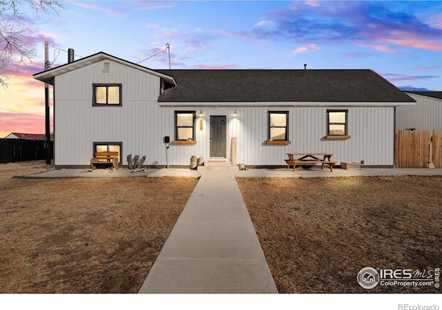 view of front of home featuring a patio area and a lawn