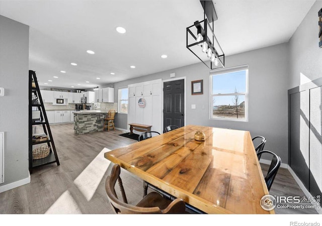 dining area with dark hardwood / wood-style floors