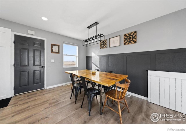 dining room featuring radiator heating unit and hardwood / wood-style floors