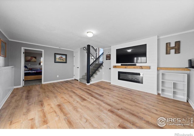 unfurnished living room featuring crown molding and light hardwood / wood-style flooring