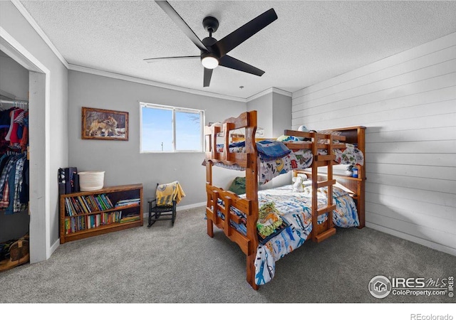 bedroom with crown molding, carpet floors, and a textured ceiling