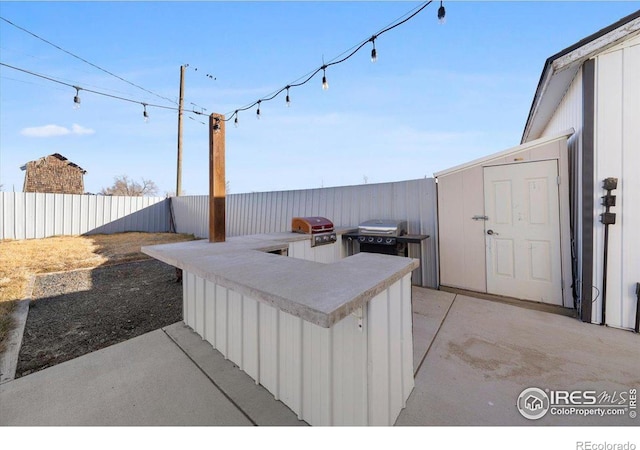 view of patio / terrace featuring a grill and an outdoor kitchen