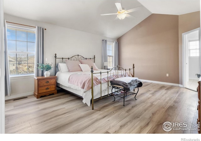 bedroom with light hardwood / wood-style flooring, ceiling fan, and vaulted ceiling