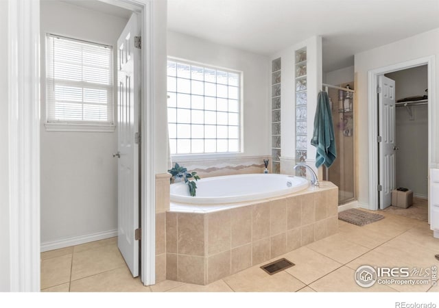 bathroom with tile patterned flooring and independent shower and bath