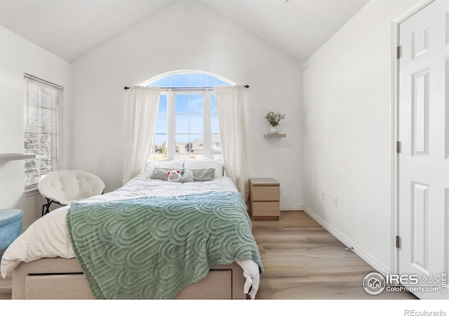 bedroom featuring vaulted ceiling and light hardwood / wood-style floors