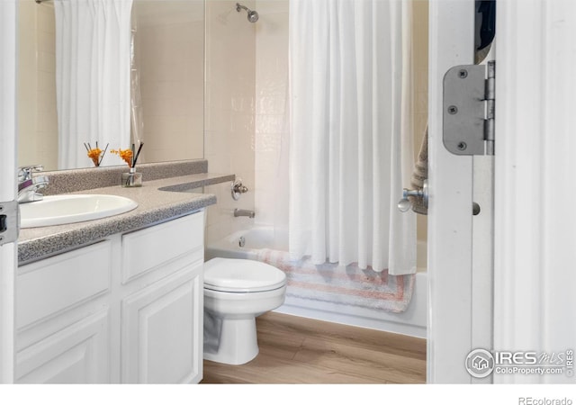 bathroom with hardwood / wood-style flooring, vanity, and toilet