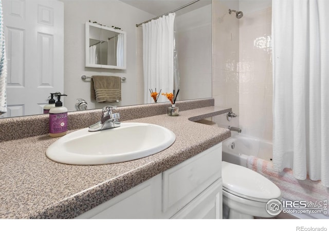 full bathroom featuring vanity, shower / tub combo with curtain, and toilet