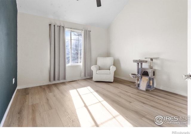 unfurnished room featuring ceiling fan, vaulted ceiling, and light wood-type flooring