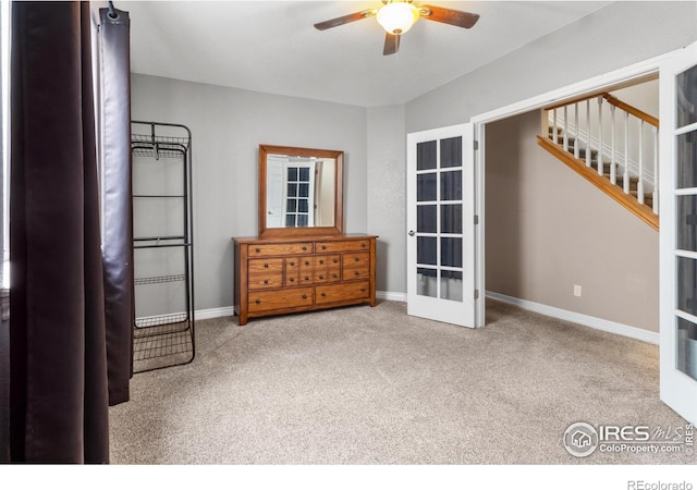 unfurnished room featuring light colored carpet, ceiling fan, and french doors