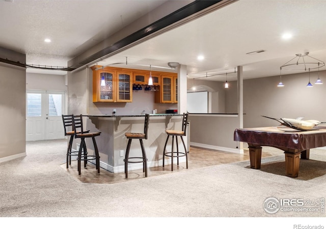 kitchen with pool table, decorative light fixtures, and light colored carpet