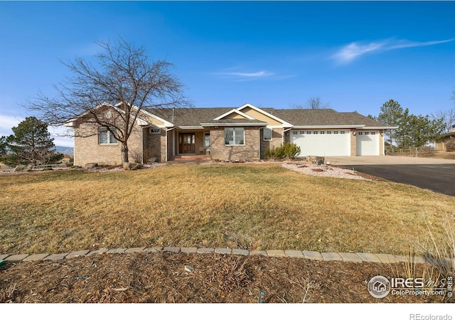 ranch-style home featuring a garage and a front yard