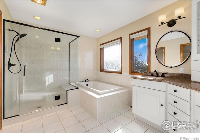 bathroom with tile patterned floors, plus walk in shower, and vanity