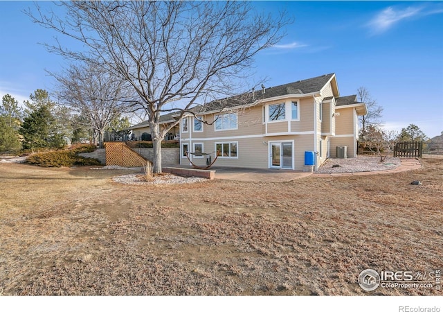 rear view of house featuring cooling unit and a patio