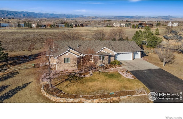 drone / aerial view featuring a mountain view and a rural view