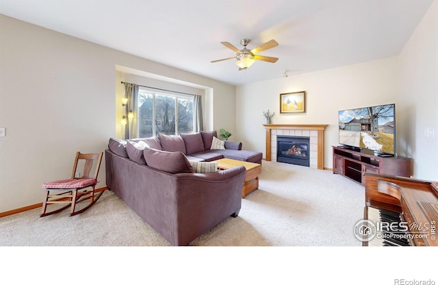 carpeted living room with ceiling fan and a fireplace