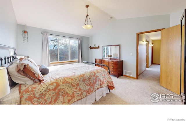 bedroom featuring vaulted ceiling and light carpet