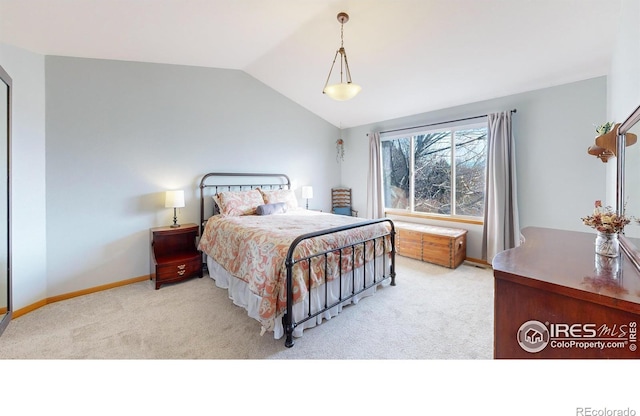 bedroom featuring light colored carpet and lofted ceiling