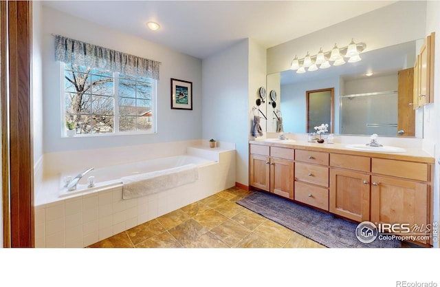 bathroom featuring vanity and separate shower and tub