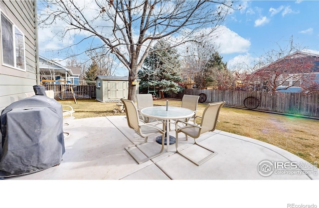 view of patio / terrace featuring grilling area and a storage shed