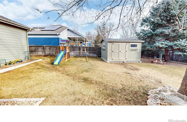 view of yard featuring a shed and a playground