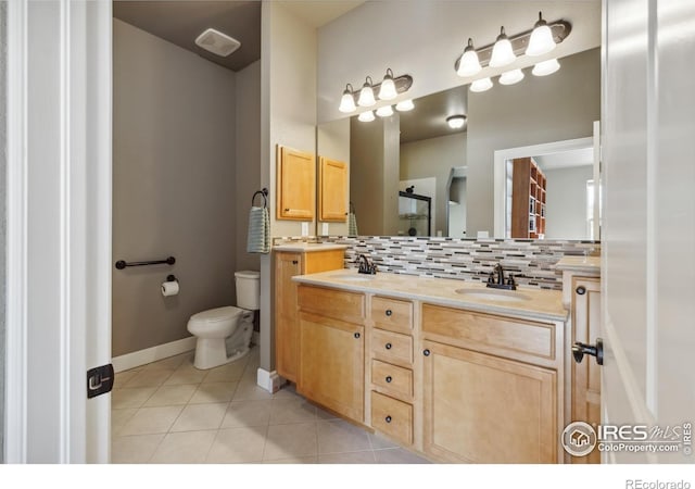 bathroom featuring tasteful backsplash, vanity, toilet, and tile patterned floors