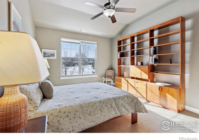 carpeted bedroom featuring lofted ceiling and ceiling fan