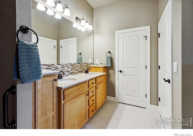 bathroom featuring tile patterned floors, vanity, and tasteful backsplash