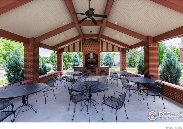 view of patio / terrace with a gazebo, ceiling fan, and an outdoor brick fireplace