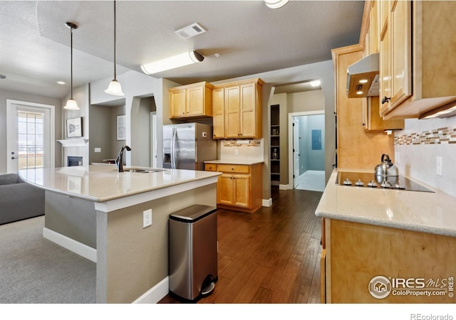 kitchen featuring sink, wall chimney exhaust hood, light brown cabinetry, and stainless steel refrigerator with ice dispenser