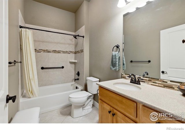 full bathroom featuring tile patterned floors, shower / bath combo with shower curtain, toilet, tasteful backsplash, and vanity