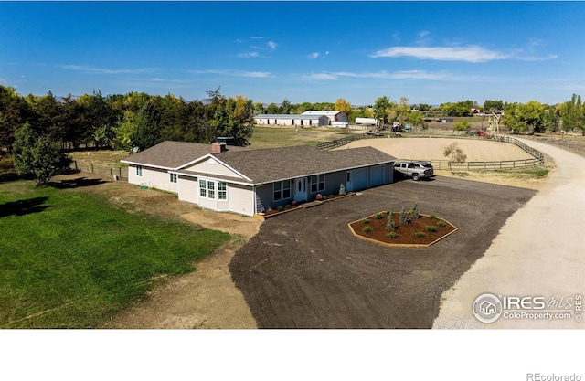 view of front of property with driveway, a front yard, and fence