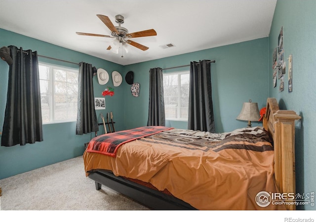 bedroom with carpet, visible vents, and a ceiling fan