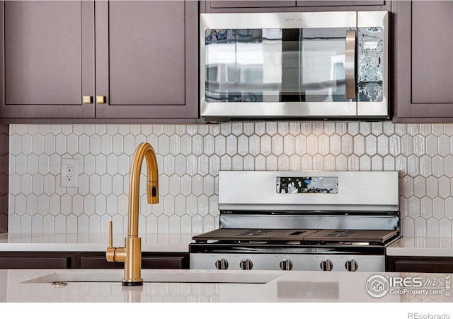 kitchen with decorative backsplash and gray cabinetry