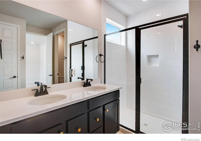 bathroom featuring vanity and a shower with door